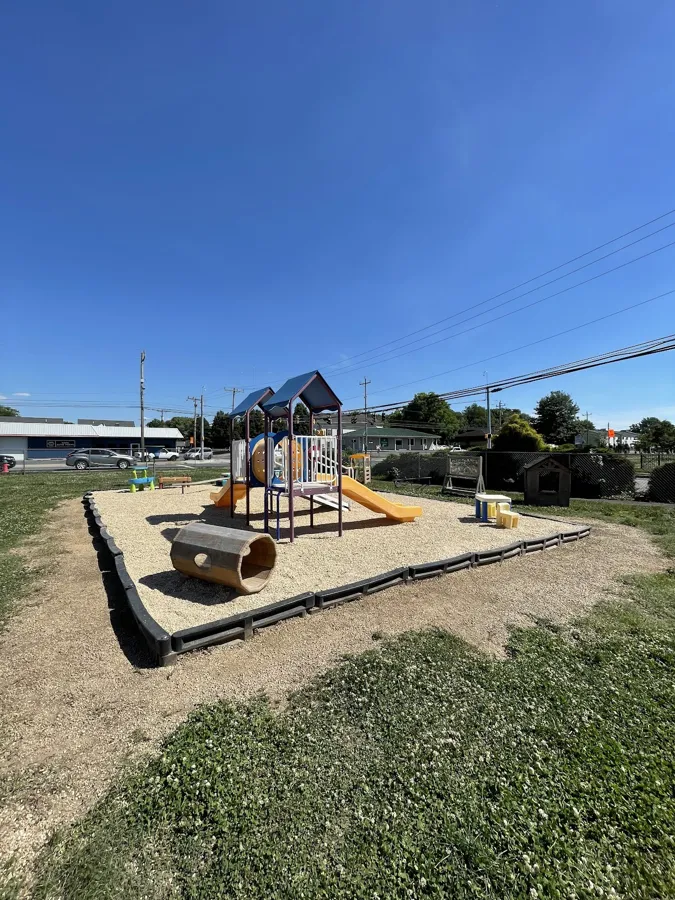 Playset area edged with a black border and filled with fresh gravel